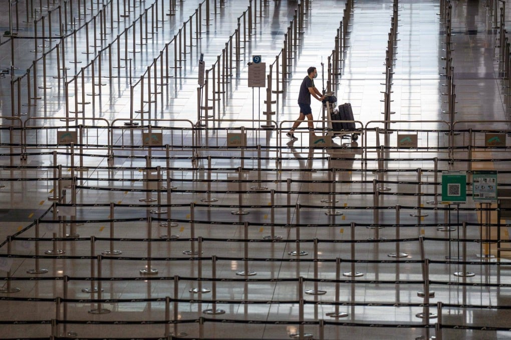 A traveller walks through the arrivals hall at Hong Kong International Airport on August 8. The aviation industry in Asia is unlikely to recover to 2019 levels before 2025. Photo: Bloomberg