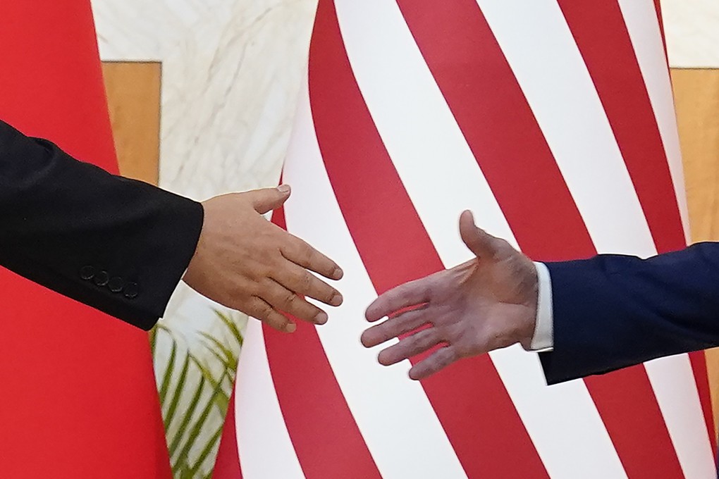 Chinese President Xi Jinping (left) and US President Joe Biden reach out to shake hands before their meeting on the sidelines of the G20 summit on in Bali, Indonesia, on November 14. Photo: AP