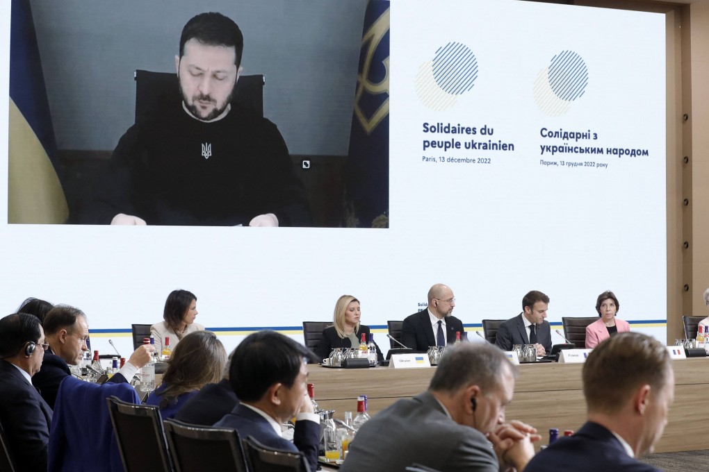 Ukrainian President Volodymyr Zelensky is pictured on a video screen during an aid conference for Ukraine on Tuesday. Photo: AFP