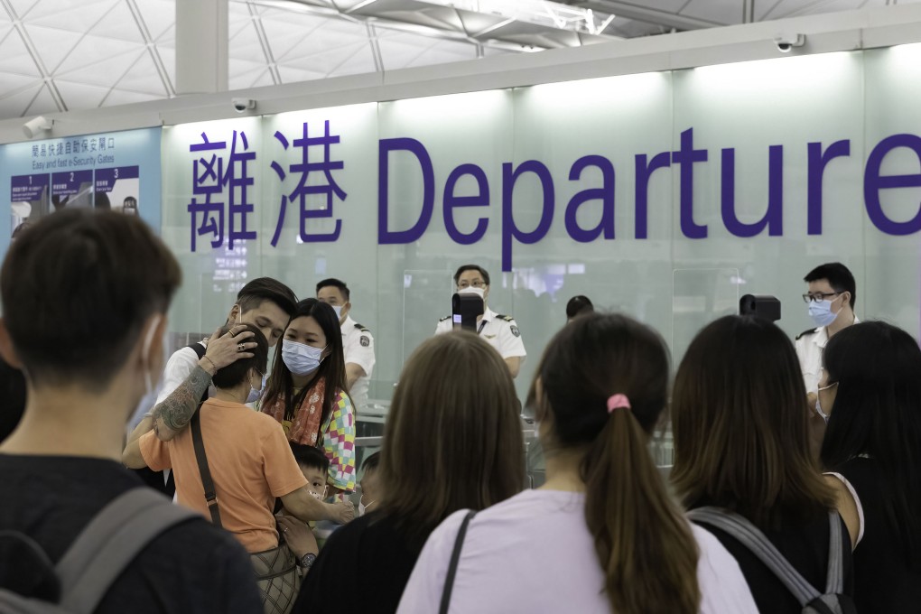 A man hugs his mother as he departs to the UK from Hong Kong with his wife. Photo: Getty