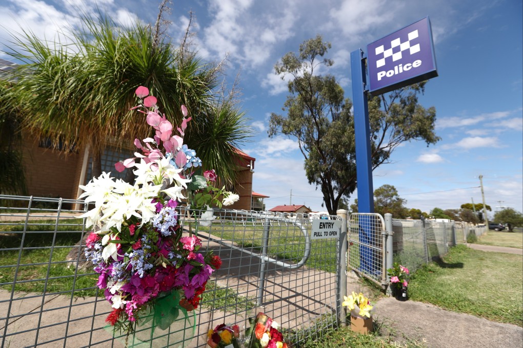 Floral tributes are seen at a police station in Tara, Queensland, on Tuesday after an ambush in which two officers and a bystander were killed. Photo: EPA-EFE