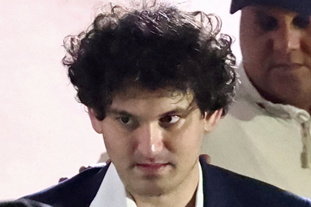 Sam Bankman-Fried being escorted out of the Magistrate Court building after his arrest in Nassau, Bahamas. Photo: Reuters