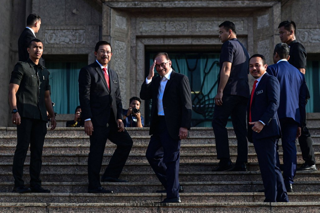 Malaysian Prime Minister Anwar Ibrahim (centre) salutes after the first monthly gathering of the prime minister’s office in Putrajaya on November 29. Photo: Malaysia’s Department of Information/AFP