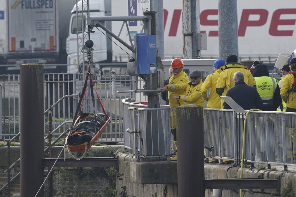 UK emergency staff remove a stretcher holding a body bag from a lifeboat after it returned to Dover following a search and rescue operation in the Channel off the coast of Kent on Wednesday. Photo: via AP