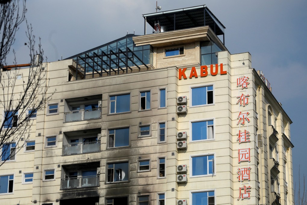 A hotel sits charred from fire in Kabul, Afghanistan, on December 13. Chinese nationals were wounded in an attack on the hotel on December 12 that Isis claimed responsibility for. Photo: Reuters
