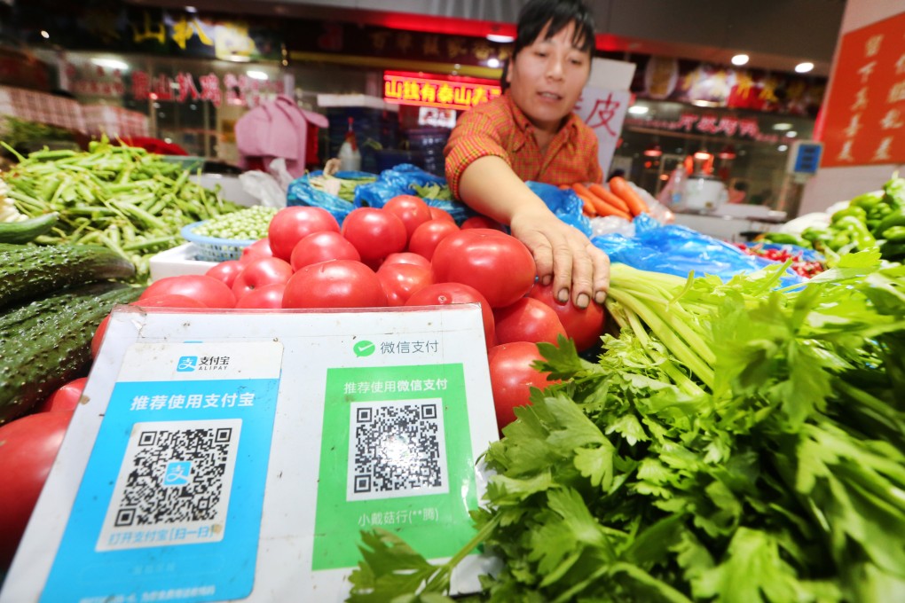QR codes of Tencent’s WeChat Pay and Ant Group’s Alipay at a wet market in eastern China’s Jiangsu province. Photo: ImagineChina via AFP