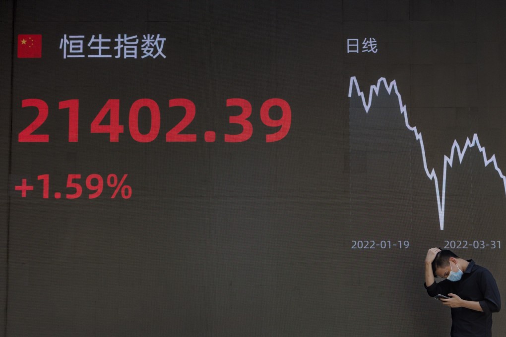 A man stands in front of a screen showing the latest economy and stock exchange updates in Shanghai on June 15. The past year has been nearly a perfect storm for China and other Asian economies, but shifting winds could turn in their favour in 2023. Photo: EPA-EFE