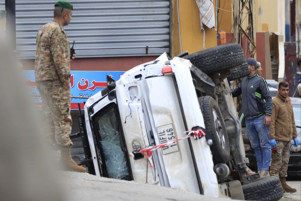 Lebanese soldiers stand next to an overturned UN peacekeeper vehicle at the scene where a convoy came under gunfire. Photo: AP