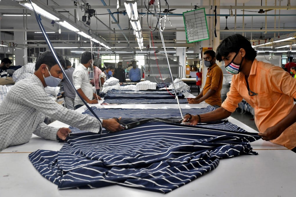 Garment workers cut fabric to make shirts at a textile factory in Hindupur town in the southern state of Andhra Pradesh, India, on February 9. Unlike other major economies with ageing populations, India enjoys a demographic dividend with its army of young workers. Photo: Reuters