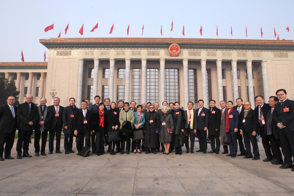 Hong Kong delegates to the NPC pose for a group photo before a session of the NPC meeting at the Great Hall of the People in Beijing, on March 13, 2018. Photo: Simon Song