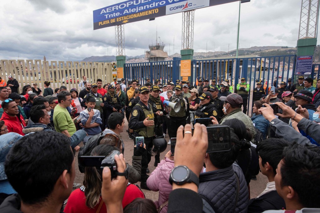 Tourist police guard the entrance to the Alejandro Velasco Astete International Airport in Cusco, Peru on Thursday after it was closed due to recent protests. Photo: AFP