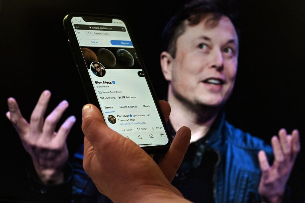 A phone displays the Twitter account of Elon Musk with an image of him displayed in the background in this photo taken on December 15, 2022. Photo: AFP