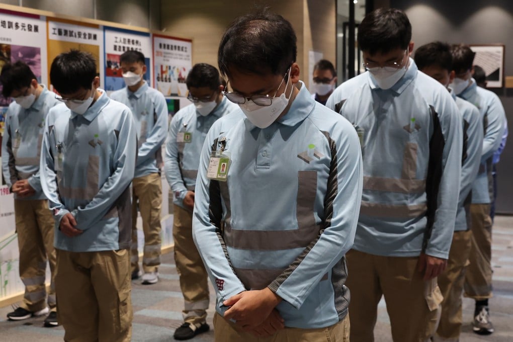 Construction trainees observe a moment of silence to mourn deaths in their occupation. Photo: Edmond So