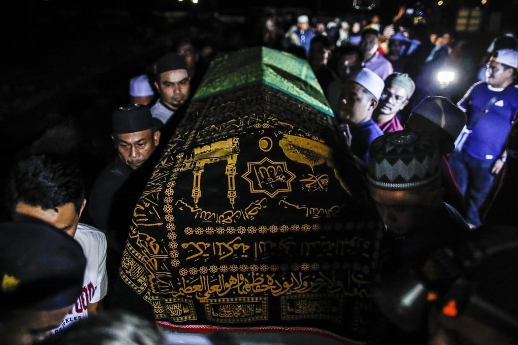 Family members carry the coffin of 31-year-old Nurul Azwani Kamarulzaman, one of the victims killed by a landslide, during a funeral procession outside Kuala Lumpur, Malaysia on Saturday. Photo: EPA-EFE