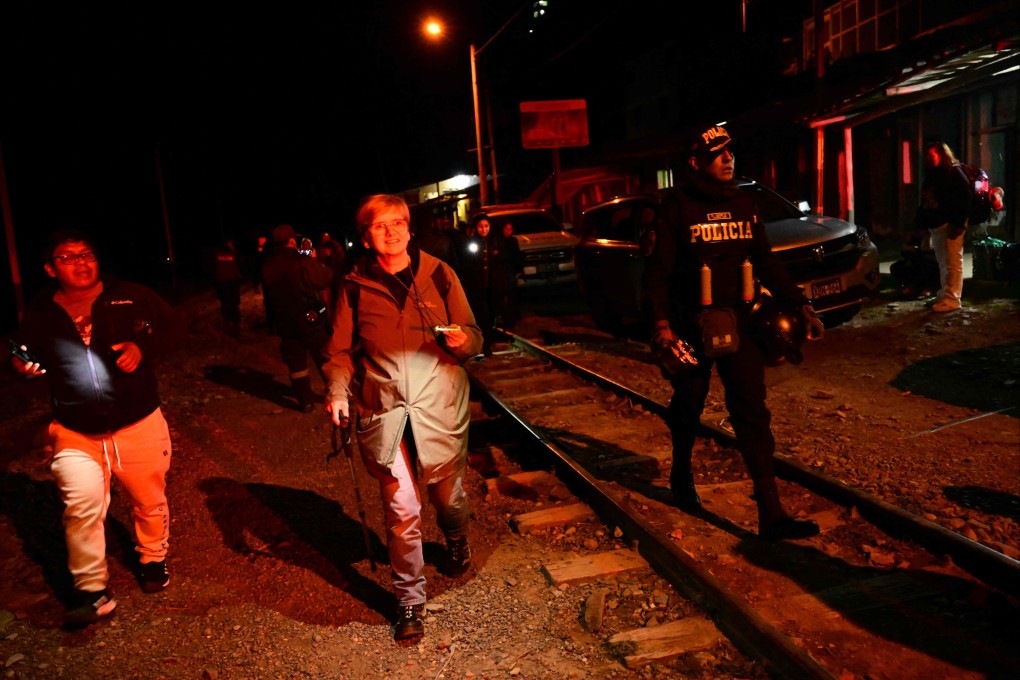 Stranded tourists who were visiting the Inca citadel of Machu Picchu arrive to Ollantaytambo, Peru, after being evacuated by train on Saturday. Photo: AFP