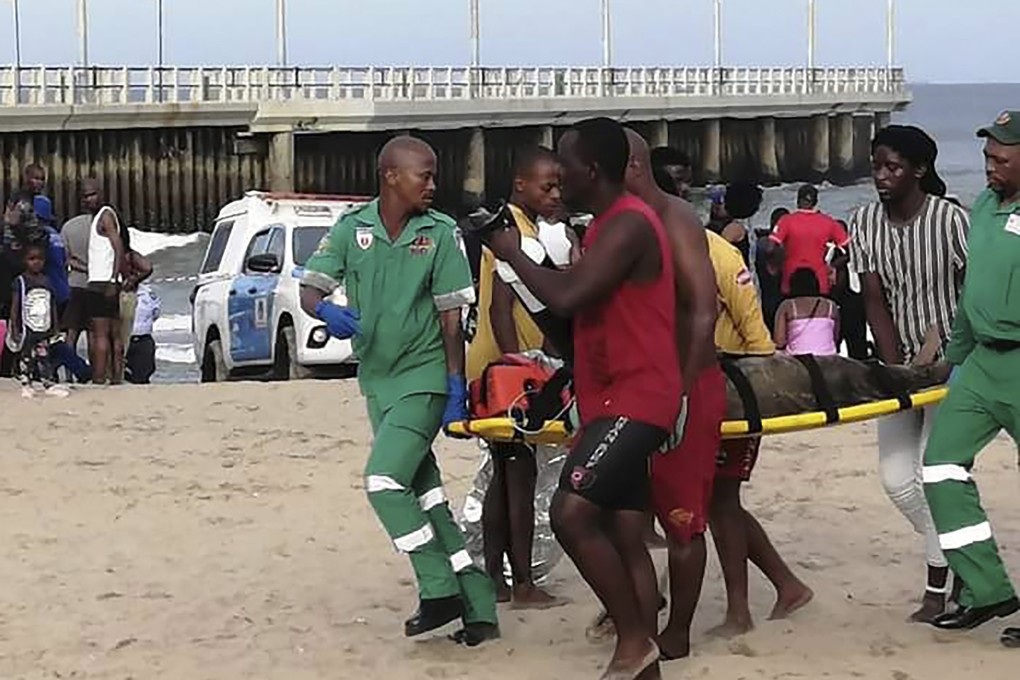 Paramedics carry a person on a stretcher on the Bay of Plenty Beach in Durban, South Africa on Saturday. Photo: AP