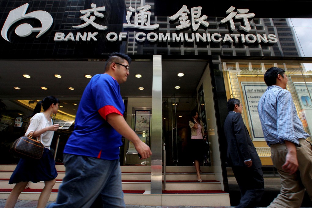 People walk past the Bank of Communications outlet in Ccentra, Hong Kong. Photo: Reuters
