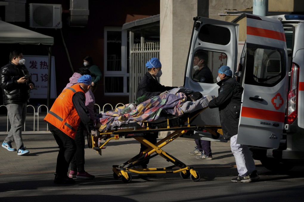 A patient is wheeled into the fever clinic in Beijing on Monday amid a surge of cases in the capital. Photo: AP