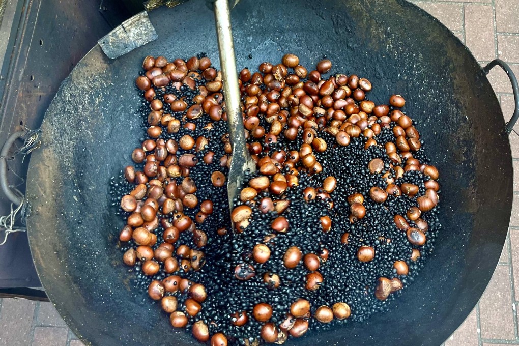 Chestnuts roasting on Kobus Tsang and his mother Tsang Chi-lee’s hawker cart. A common sight on Hong Kong streets in winter, hawker cart numbers are shrinking amid official measures to discourage the practice. Photo: Kylie Knott