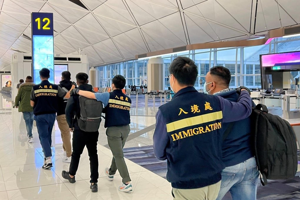 Immigration officers escort unsuccessful  non-refoulement claimants as they leave Hong Kong in November. Photo: SCMP Pictures