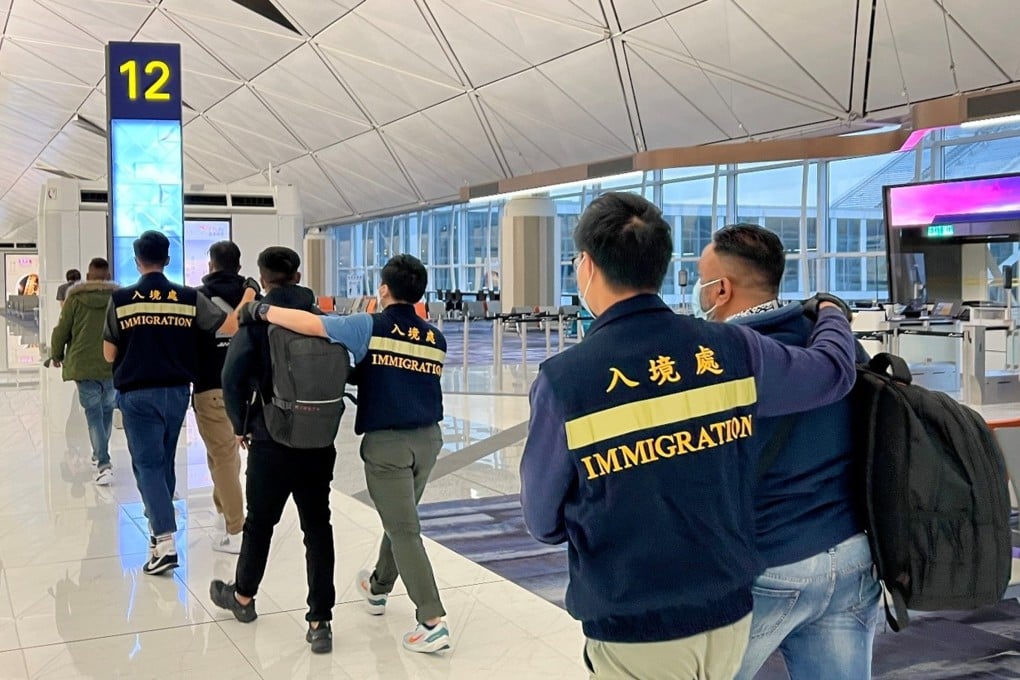 Immigration officers escort unsuccessful non-refoulement claimants as they leave Hong Kong in November. Photo: SCMP Pictures