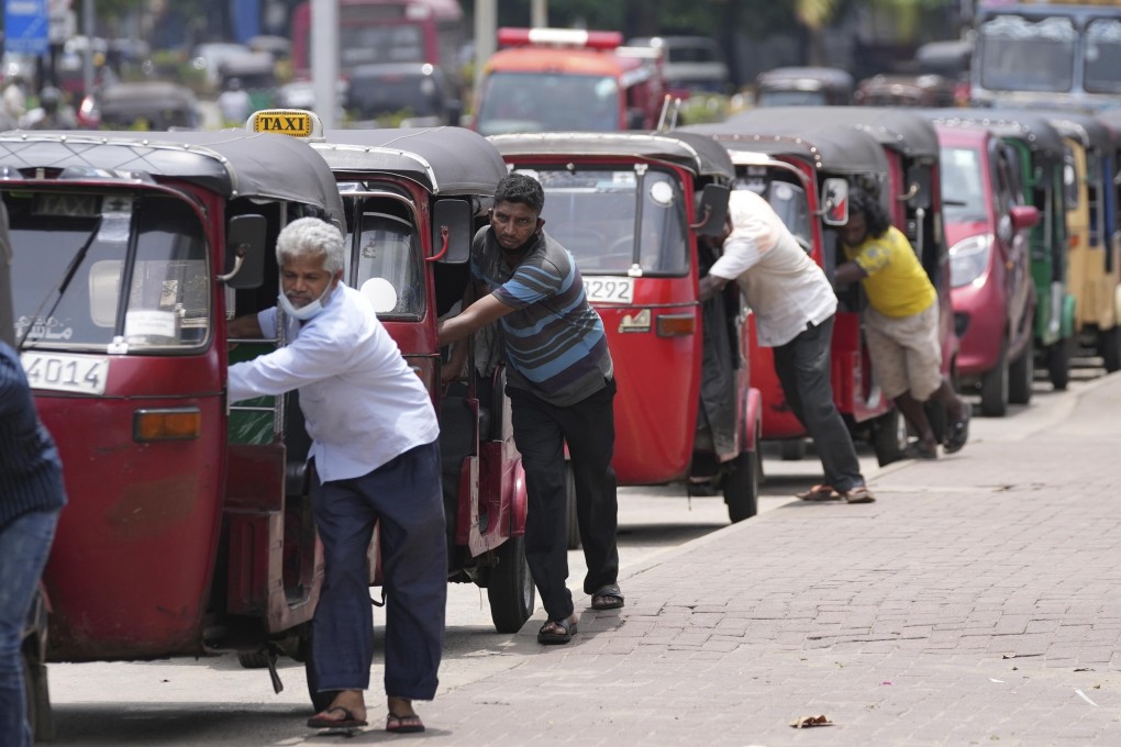 Drivers push their auto rickshaws to a petrol station in Colombo earlier this year as the crisis severely restricted Sri Lanka’s ability to import fuel. Photo: AP