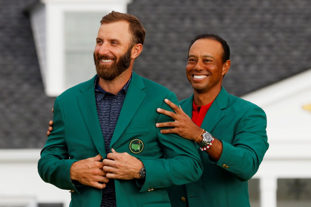 Dustin Johnson is presented with the green jacket by Tiger Woods after winning The 202 Masters. Photo: Reuters