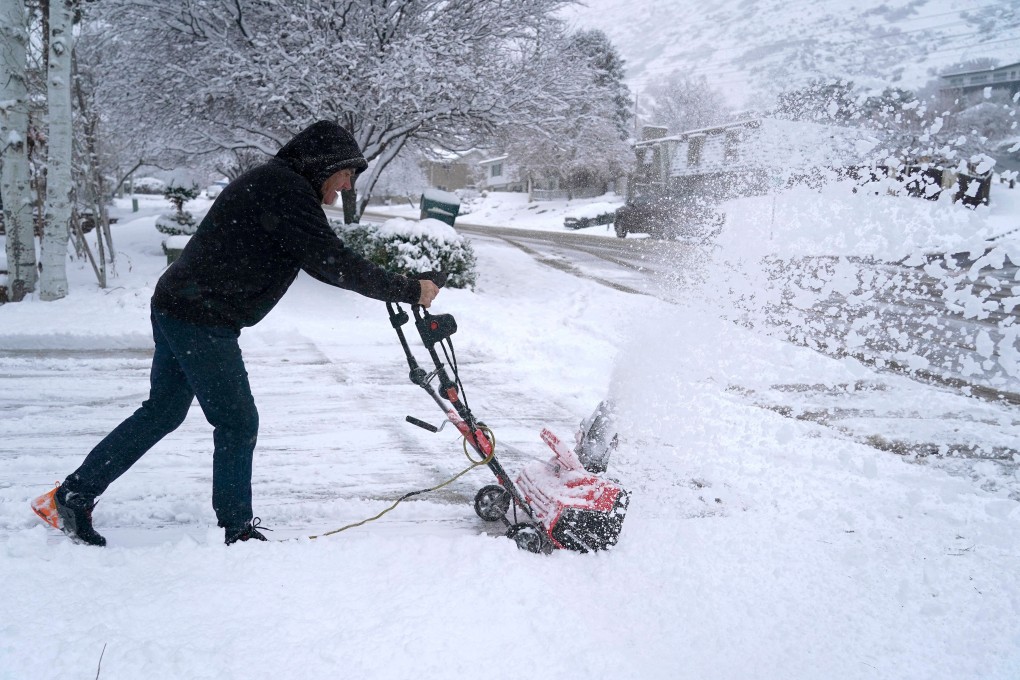 A man clears his driveway of snow after a storm in Utah, US. Photo: TNS