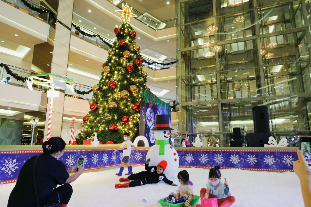 Children play in artificial snow near a Christmas tree at a Jakarta shopping centre this month. A resident of Surabaya said she believed it was “wrong” for Muslims to take selfies near Christmas trees. Photo: Reuters