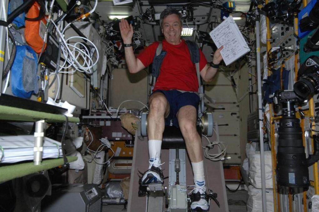 Former Canadian astronaut Robert Thirsk cycling on board the International Space Station. Astronauts on long flights to Mars will need ways to exercise, maintain mental health and avoid getting ill, researchers say. Photo: Nasa
