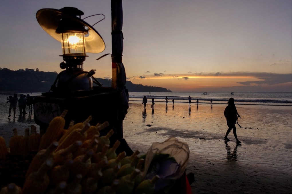 People enjoy a Bali beach at sunset. Photo: Reuters