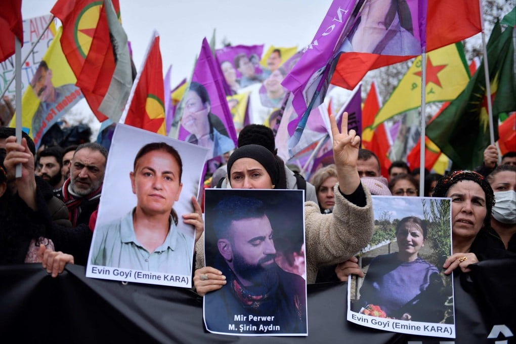 Supporters and members of the Kurdish community hold portraits of victims Emine Kara and Mir Perwer during a demonstration at The Place de la Republique in Paris on Saturday. Photo: AFP