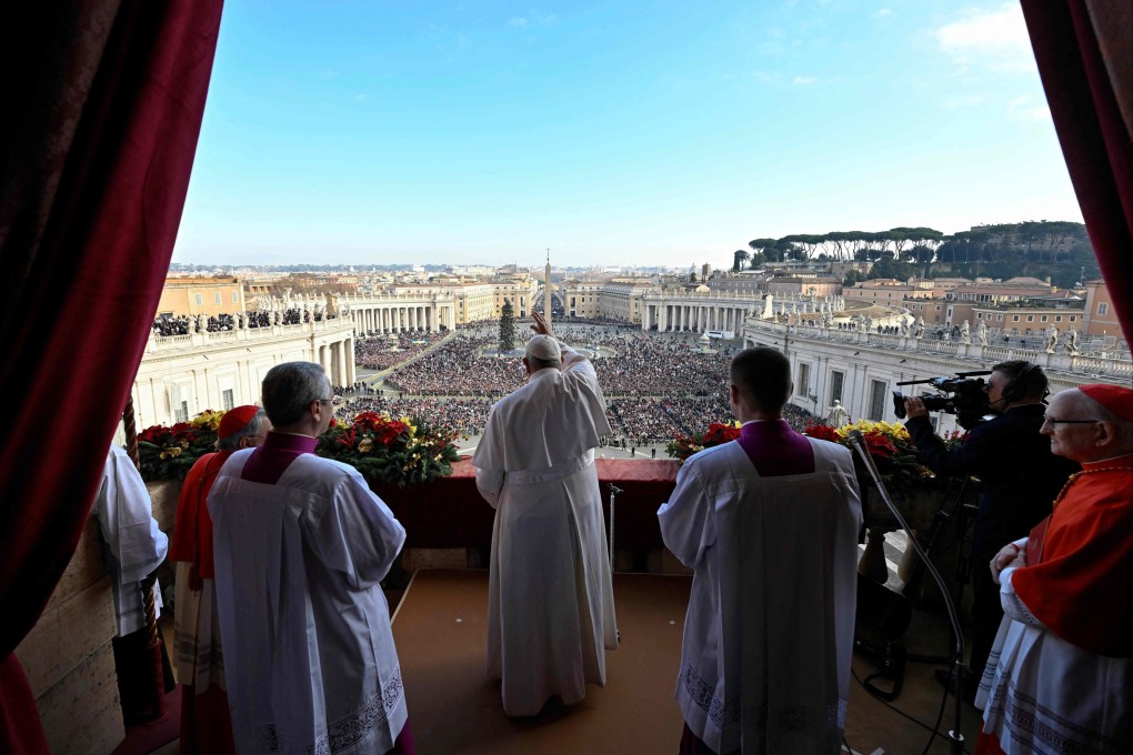 Pope Francis blesses the faithful as he delivers his Christmas blessing, as he stands on the balcony overlooking St. Peter’s Square at The Vatican. Photo: Vatican media/AFP
