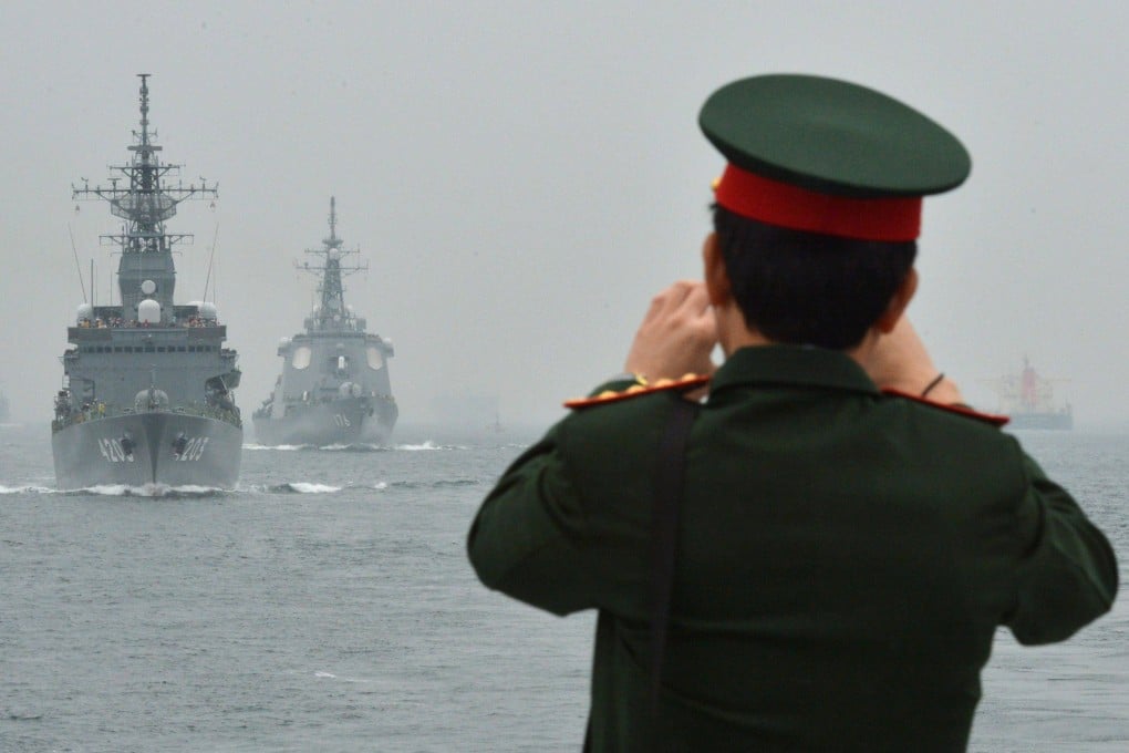 A foreign military officer on board a ship watches the Japanese Maritime Self-Defense Force (MSDF) fleet review off Sagami Bay, Japan’s Kanagawa prefecture on October 14, 2012. Photo: AFP/File
