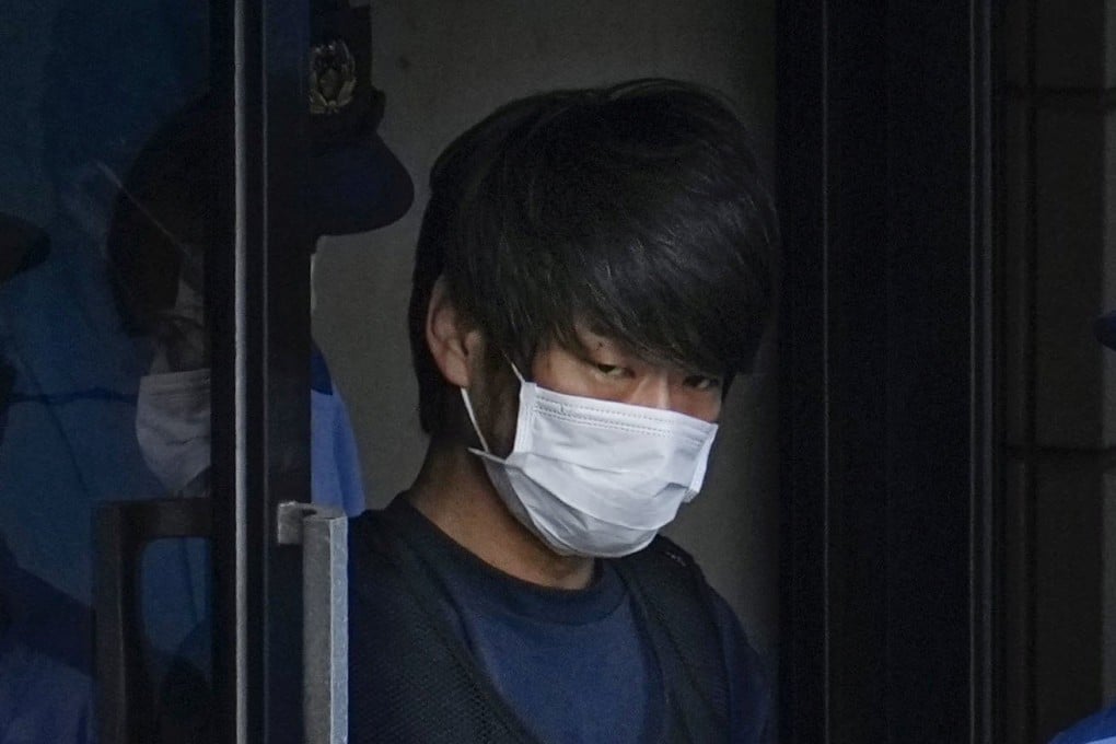 Tetsuya Yamagami is escorted by police in Nara, western Japan. Photo: Kyodo/File