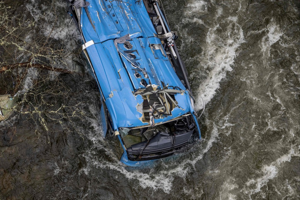 The wreck of a bus lies in the Lerez river in Spain after it plunged in while crossing a bridge on Sunday. Photo: AFP