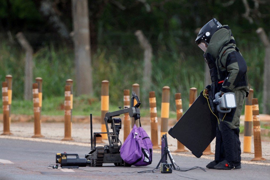 Anti-bomb officers work to defuse what is believed to be an explosive device in Brasilia, Brazil on Saturday. Photo: Reuters