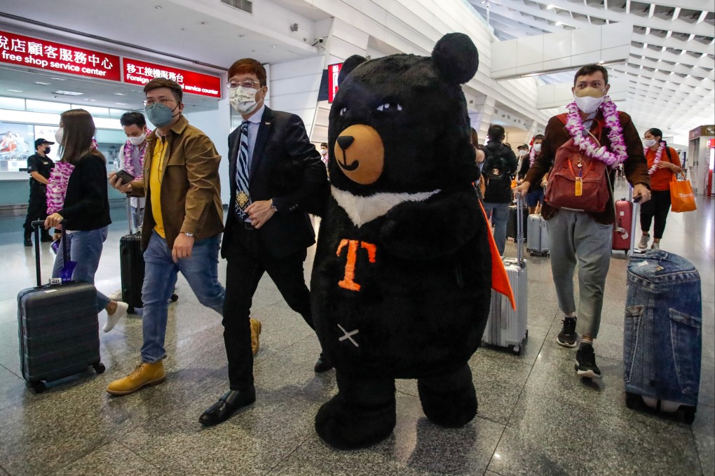 A mascot welcomes the first overseas arrivals at Taoyuan International Airport in October after Taiwan reopened its borders by ending mandatory Covid-19 quarantine for arrivals. Photo: AFP
