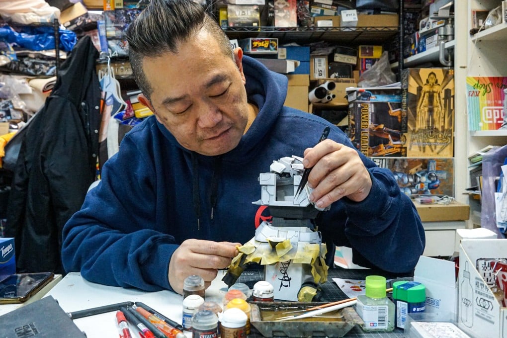 Manson Ng at his store and workshop in Hong Kong’s Mong Kok district, where he builds Gundam models, or “Gunpla”, for a living – and for a hobby. Now 53, Ng was the over-21s champion of this year’s Gunpla Builders World Cup. Photo: Sam Li