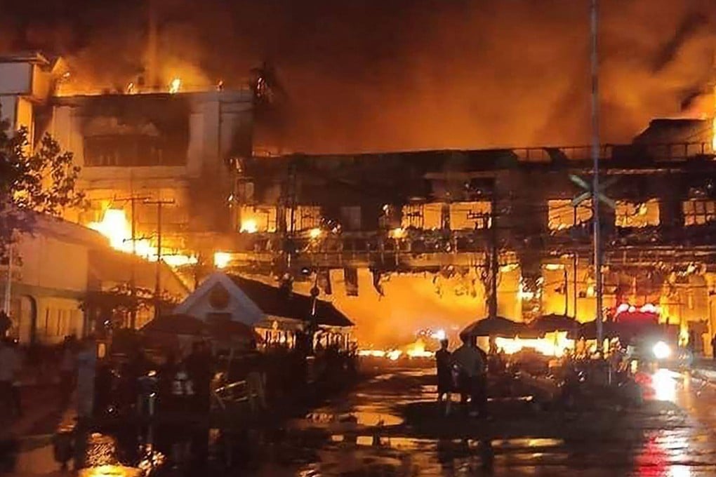 Firefighters battle a blaze at the Grand Diamond City hotel-casino in Poipet, Cambodia, on Thursday. Photo: AFP