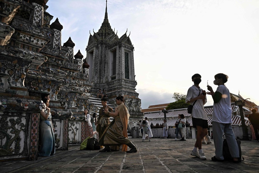 Tourists visit the Wat Arun Buddhist temple in Bangkok, Thailand. Photo: AFP