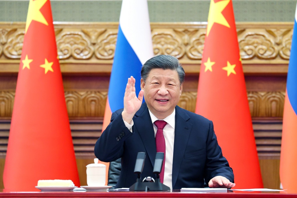 Chinese President Xi Jinping waves at the camera during Friday’s video call with Vladimir Putin. Photo: Xinhua