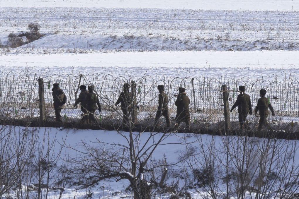 North Korean soldiers patrol on a riverside in the border county of Uiju, in a photo taken from China’s Dandong city. Photo: Kyodo