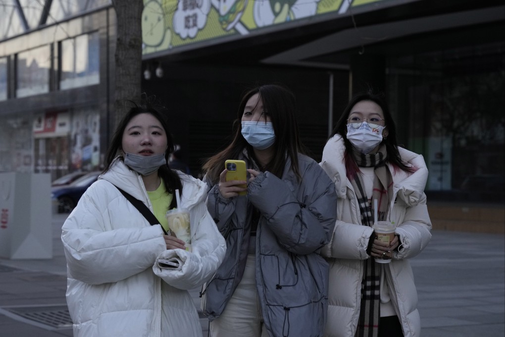 Shoppers return to Beijing’s malls, as part of China’s switch to living with Covid-19, which is surging across the country. Photo: AP