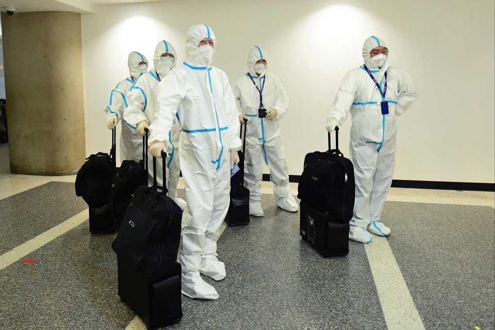 In this file photo taken on December 3, 2021, the flight crew from Air China arrive in hazmat suits in the international terminal at Los Angeles International Airport. The US will require negative Covid tests from all air travelers from China, saying Beijing is not sharing enough information about the surge in coronavirus cases there. Photo: AFP