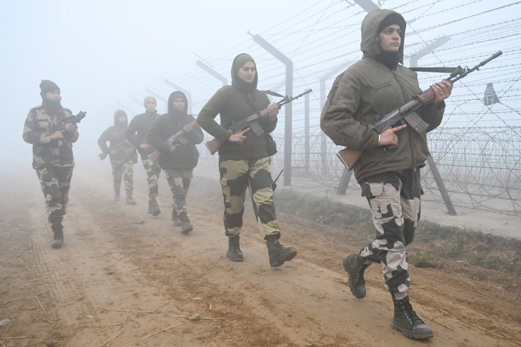 Border Security Force personnel patrol along the fence near the India-Pakistan Wagah border in December 2022. The neighbours have fought three wars and have had a number of military skirmishes in recent years. Photo: AFP