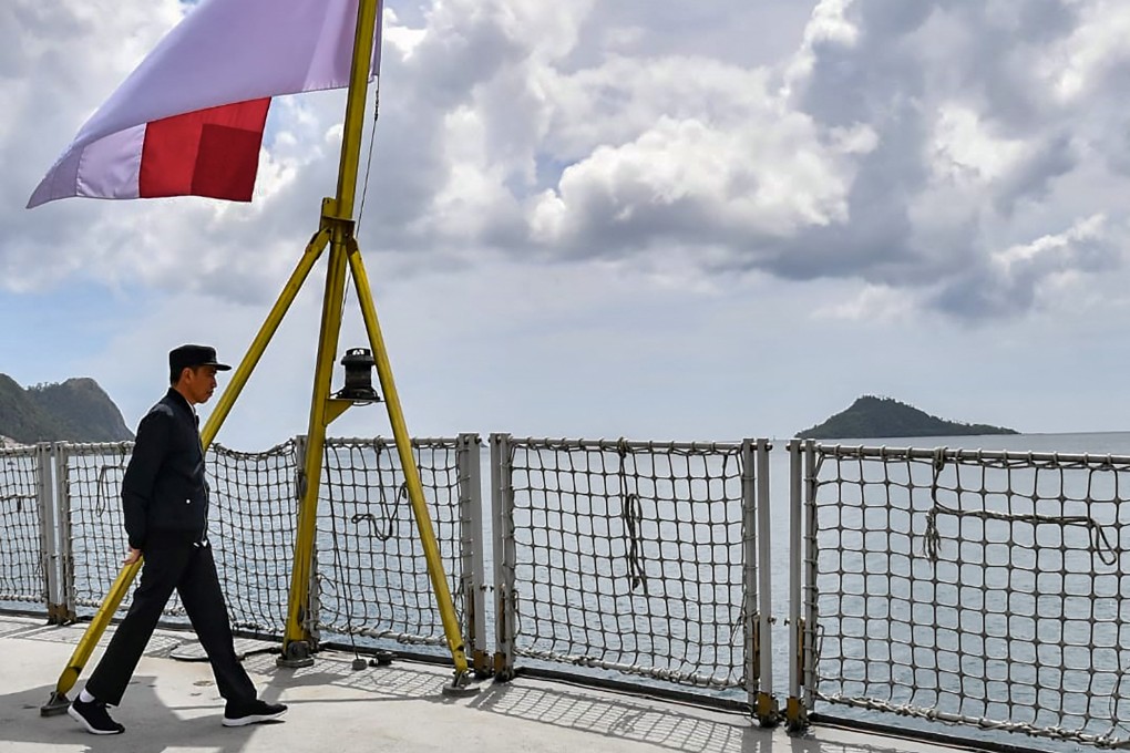 Indonesia’s President Joko Widodo walking past the country’s flag on a navy ship during his visit to a military base in the Natuna islands, which border the South China Sea. Photo: Indonesian Presidential Palace/AFP