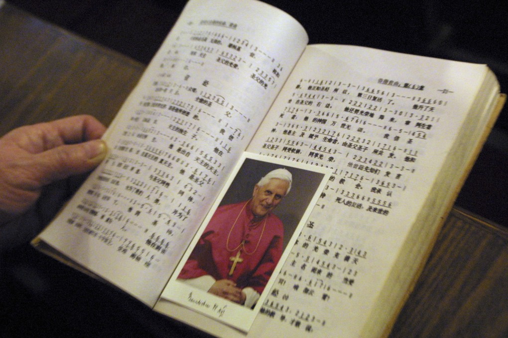 A picture of Pope Benedict XVI between the pages of a hymn book during Mass at a church in Beijing on Christmas Day in 2005. As soon as he was elected, Benedict made clear he wanted to re-establish diplomatic relations with China that were severed in 1951. The Vatican announced on December 31, 2022 that Benedict had died at age 95. Photo: AP