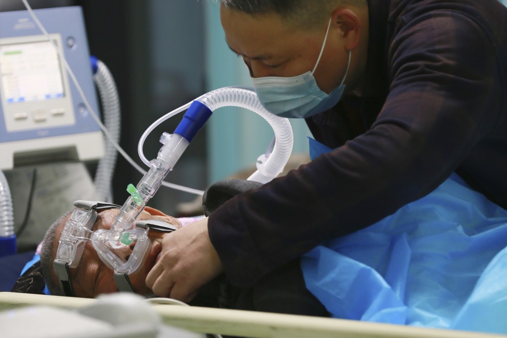 A man attends to a loved one in a hospital in Suining, Sichuan province, China on December 31, 2022. With the easing of Covid restrictions, shopping malls and restaurants in China have filled up again, while hospitals are swamped. Photo: AP
