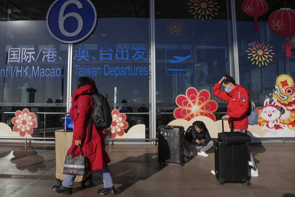 Masked traveller walk through the international flight departure terminal entrance gate at the capital airport in Beijing. Australia has joined a raft of countries, including the US and Japan, that have implemented similar restrictions as infections soar in China after the government abruptly abandoned its stringent zero-Covid policy. Photo: AP
